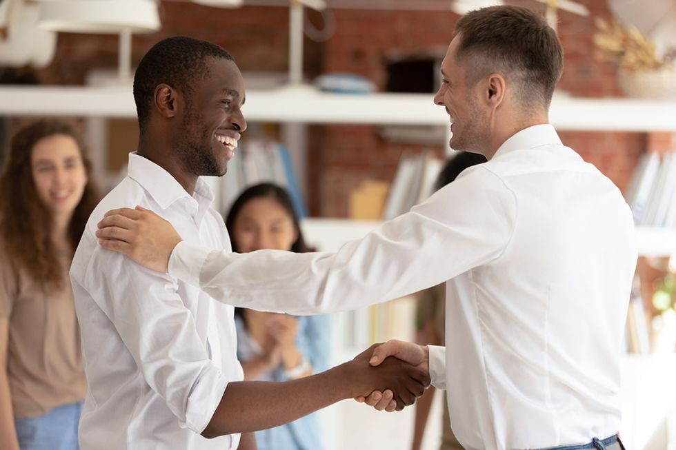 A manager rewards an employee for his good work