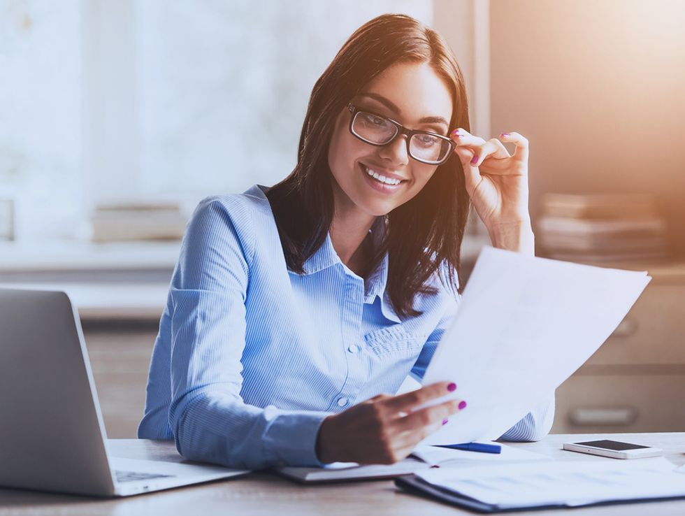 Young woman proofreads while working from home.