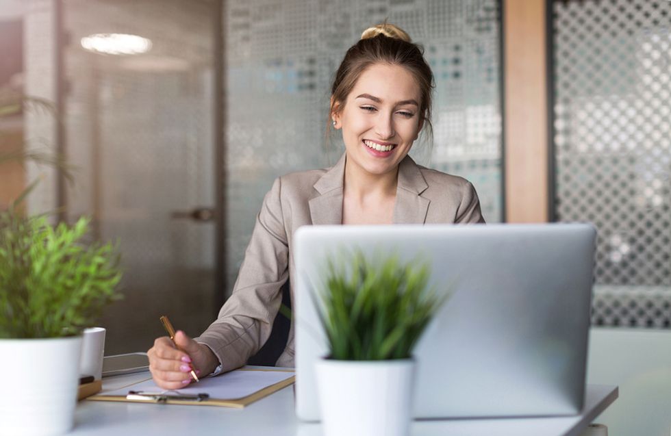 Young businesswoman getting set up for work on her first day in a new office.