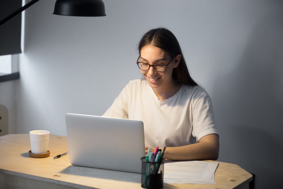 Woman referring to notes during her Skype interview
