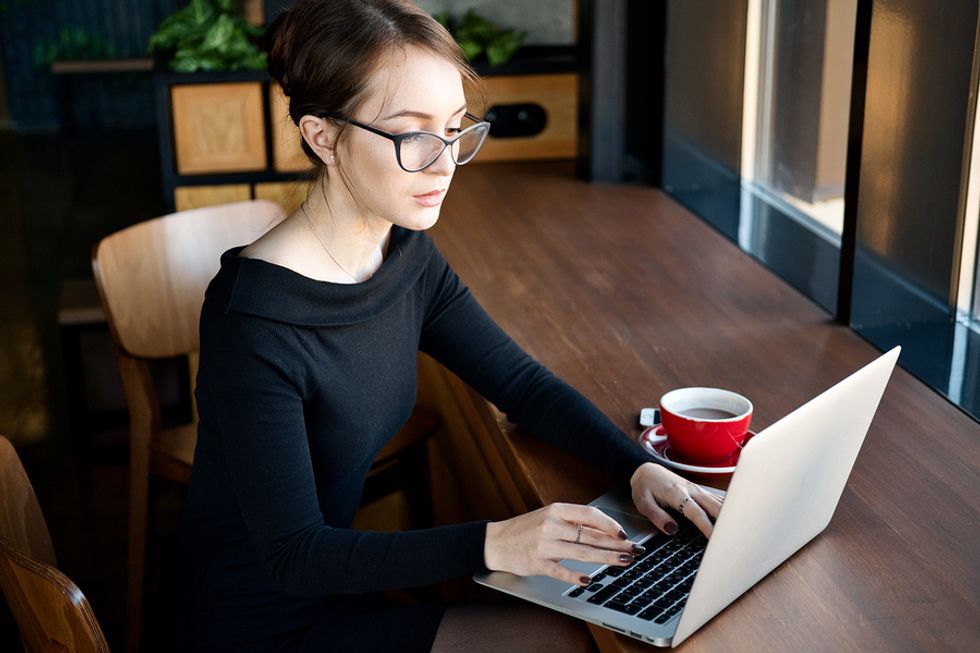 Woman writes a follow-up thank you note after a job interview