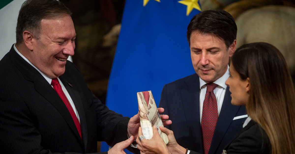 Italian Woman Gives Mike Pompeo Large Block Of Cheese To Protest Trump's Potential Cheese Tariffs