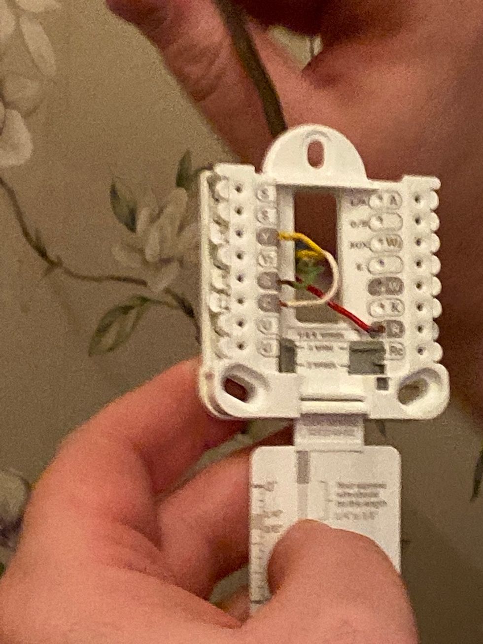 Photo of wires being inserted into Honeywell Home T9 mounting bracket.