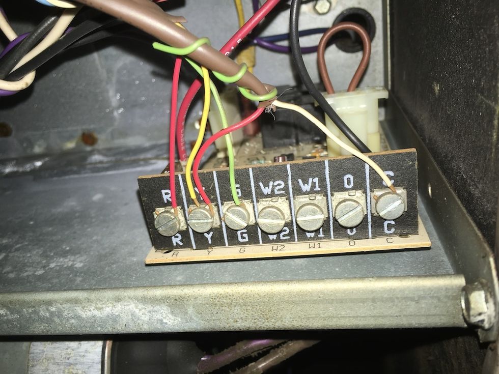 Photo of wiring board on a central air conditioning system showing a C Wire connection.