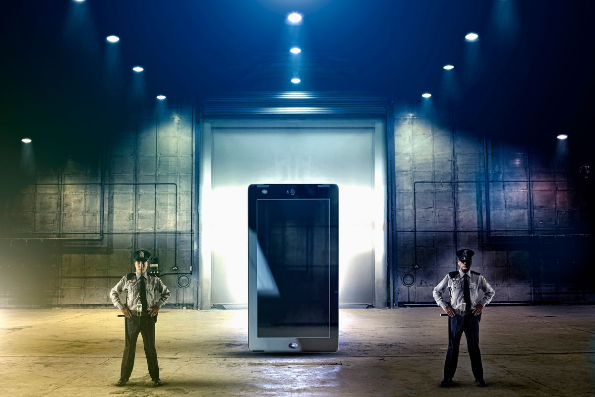 two guards guarding a giant cell phone