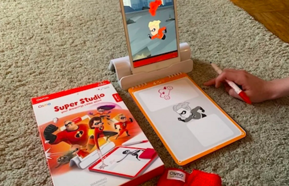 The Osmo Super Studio toy, with someone drawing a picture from the Incredibles