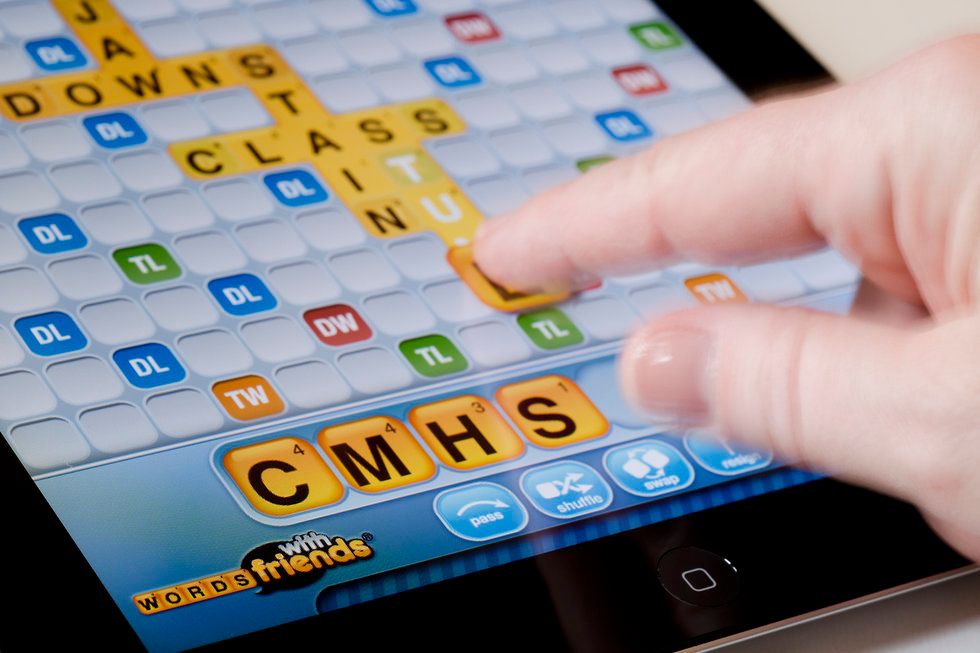 Someone playing Words with Friends on a tablet