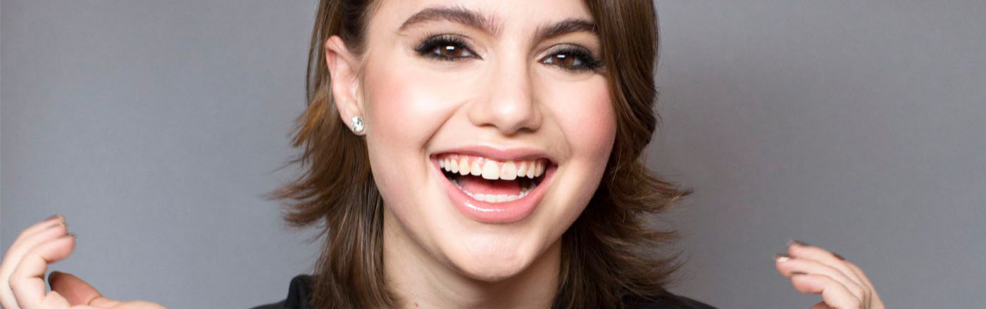 Actress Sami Gayle of Blue Bloods smiles broadly at camera