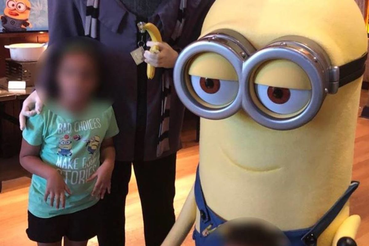 Universal Orlando employee fired for flashing a hate symbol in a photo with a biracial child