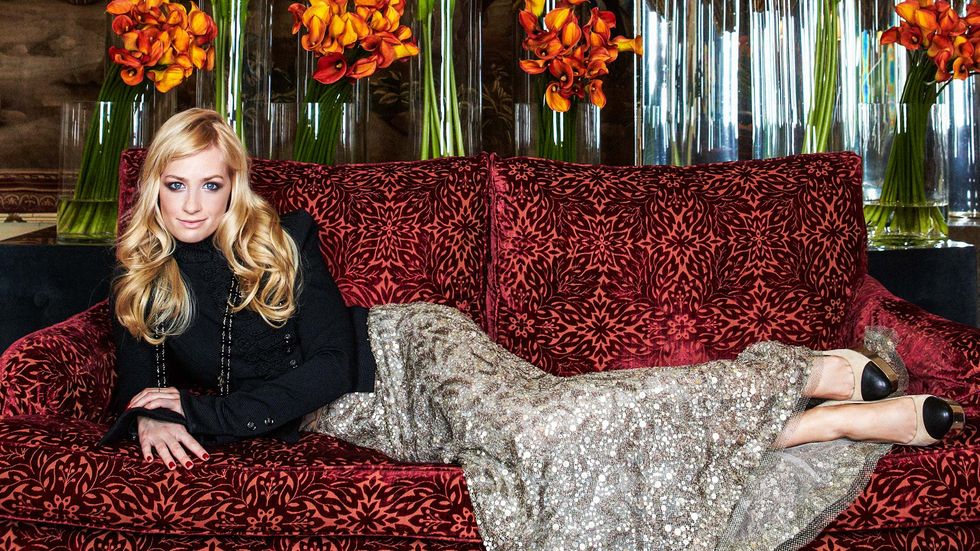 Beth Behrs laying down on couch