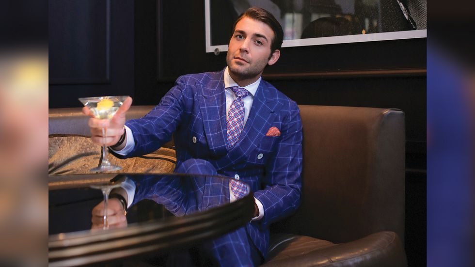 James Wolk of Tell Me A Story lounges with a martini