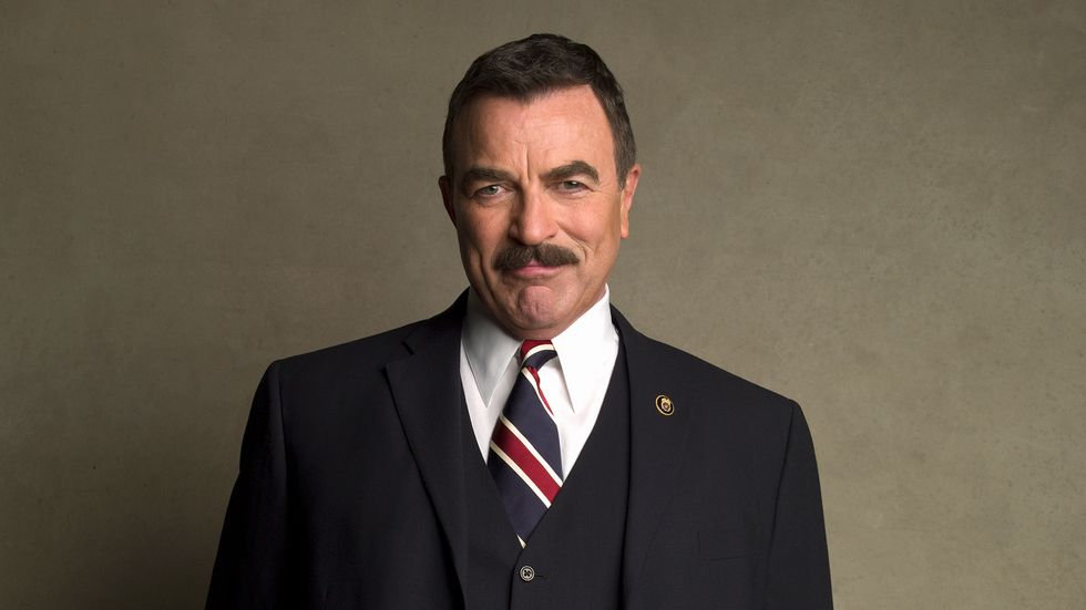Tom Selleck in navy suit with striped tie