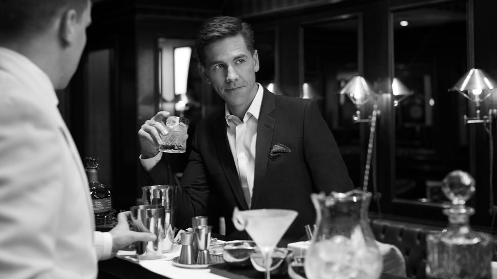 Brian Dietzen drinking cocktail at bar