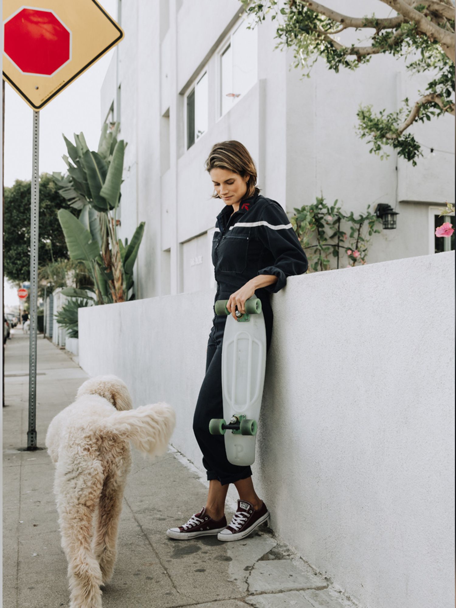 Missy Peregrym with a skateboard and a dog