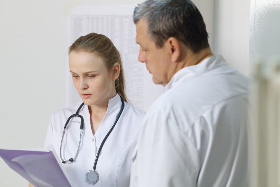 Nurse practitioner consulting with another doctor in a doctor's office.