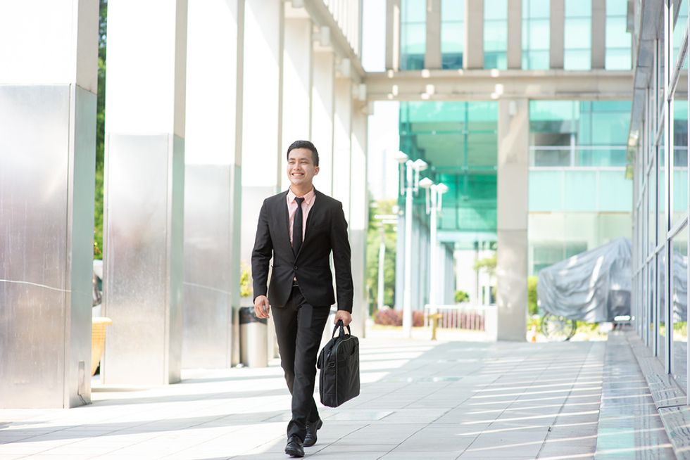 Businessman arriving at his modern office early in order to build better habits and be more productive at work.