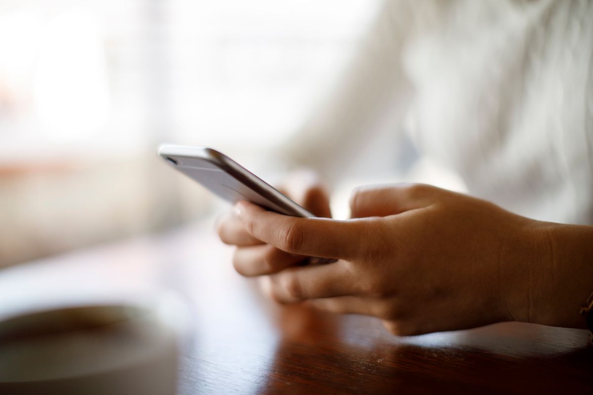 Close up of two hands holding a smartphone