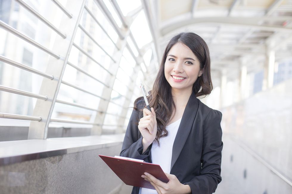 Young businesswoman reviews her performance review.