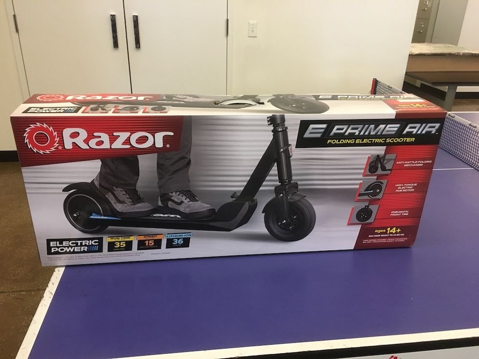 The Razor scooter box on a purple table