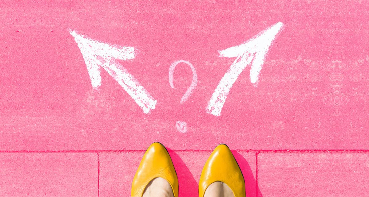 Feet planted on the sidewalk with two arrows in front of them pointing in opposite directions