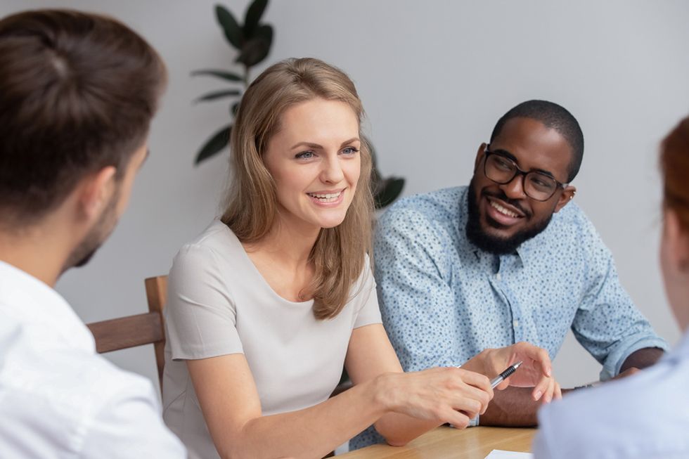 Working mom opening up to her co-workers about her responsibilities at home.