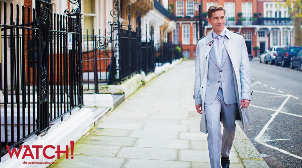 Brian Dietzen in a baby blue suit walking down the street in London