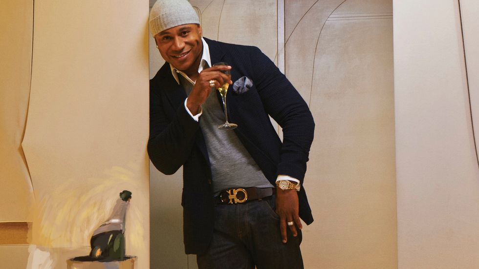 LL COOL J of NCIS Los Angeles in gray knit beanie drinking champagne