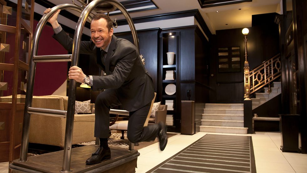Donnie Wahlberg having fun in on hotel luggage cart