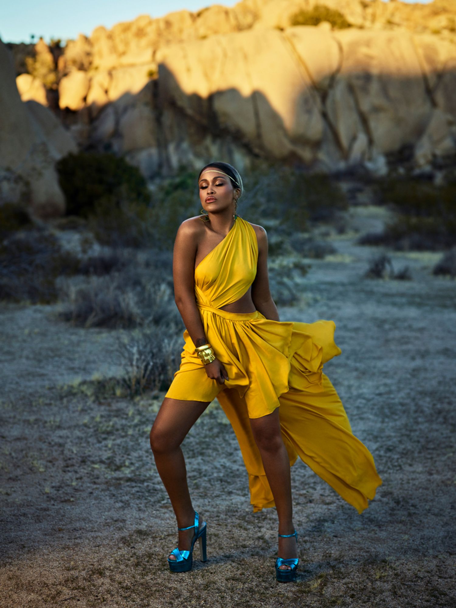 Eve of The Talk in a one shouldered yellow dress and blue shoes
