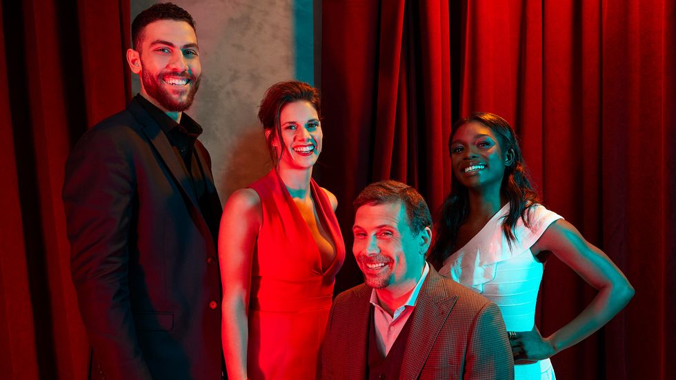 Cast of FBI in front of red curtains
