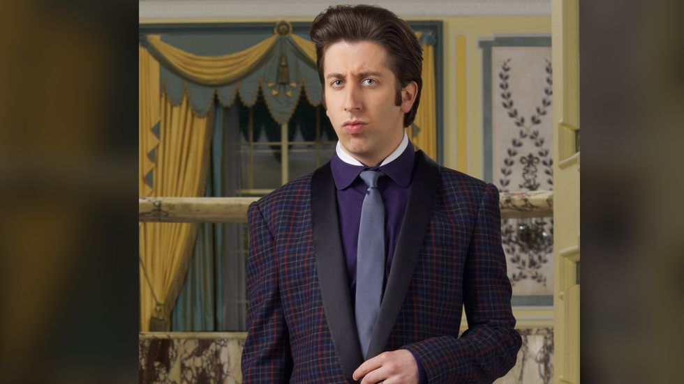 Simon Helberg of The Big Bang Theory in a dark checkered tuxedo jacket and purple shirt