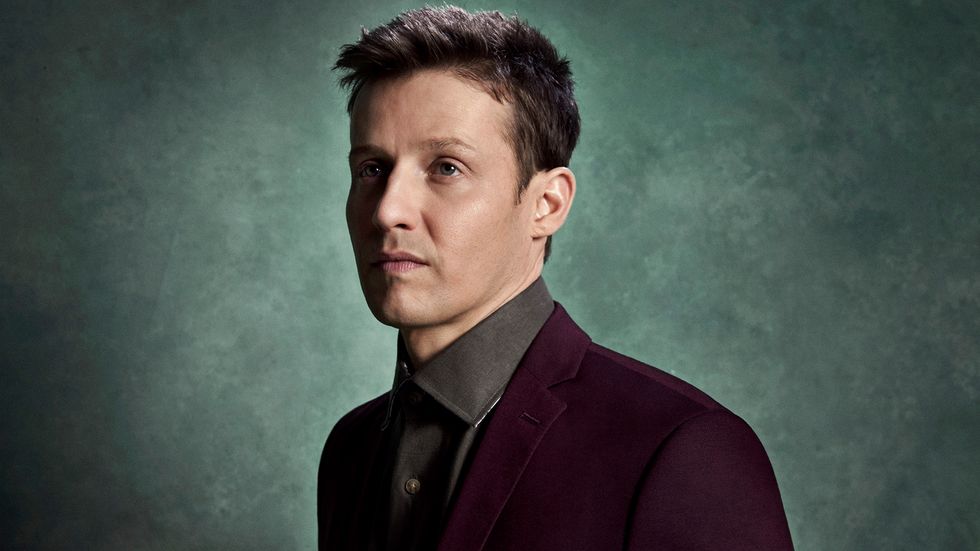 Will Estes wearing burgundy blazer
