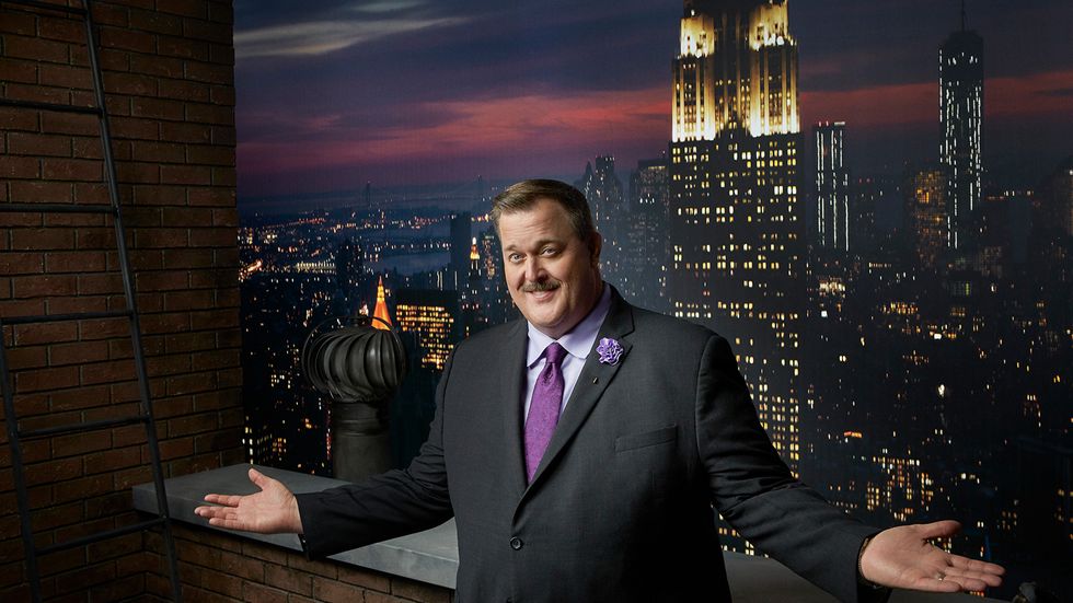 Billy Gardell in purple tie in front of the Empire State Building