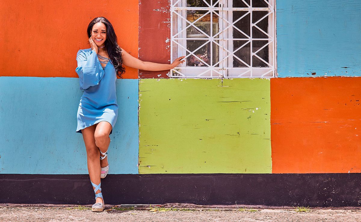 Candice Patton posing against color-blocked wall