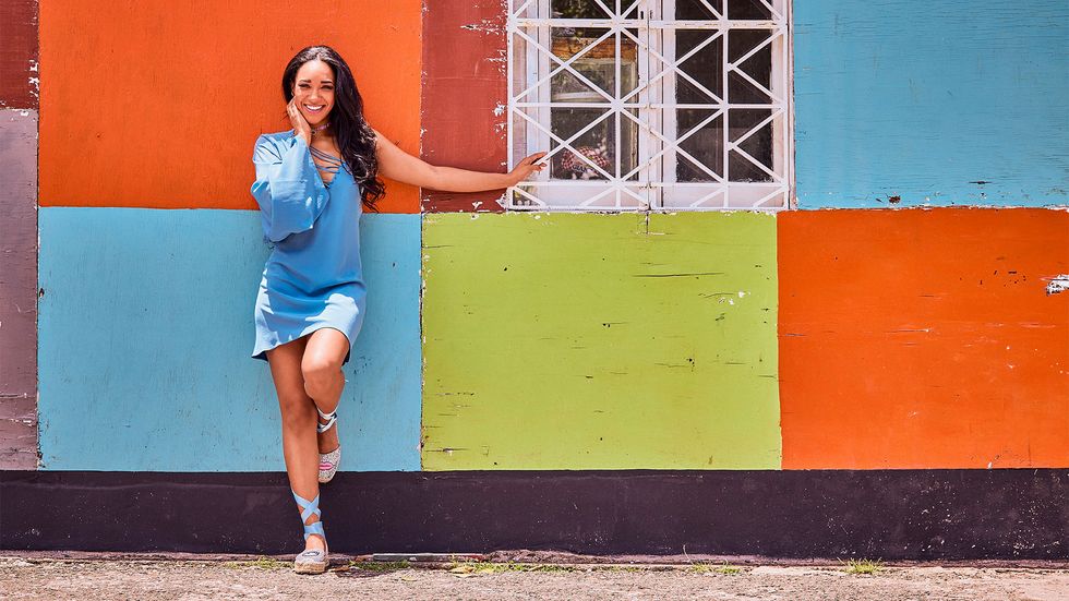Candice Patton posing against color blocked wall
