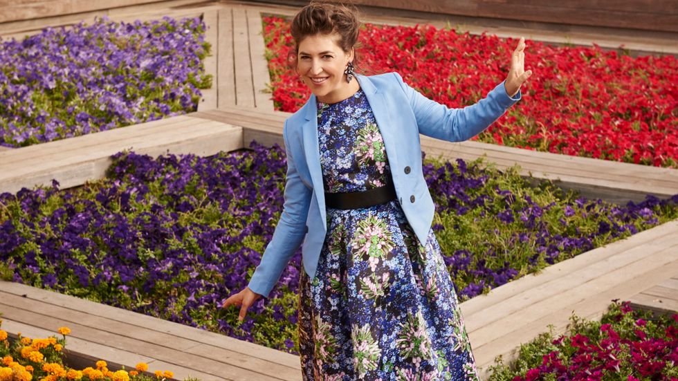 Mayim Bialik of The Big Bang Theory in blue and purple floral dress