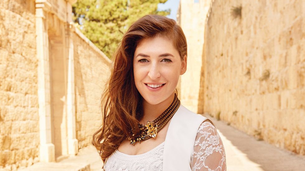 Mayim Bialik of The Big Bang Theory in lace dress and gold necklace