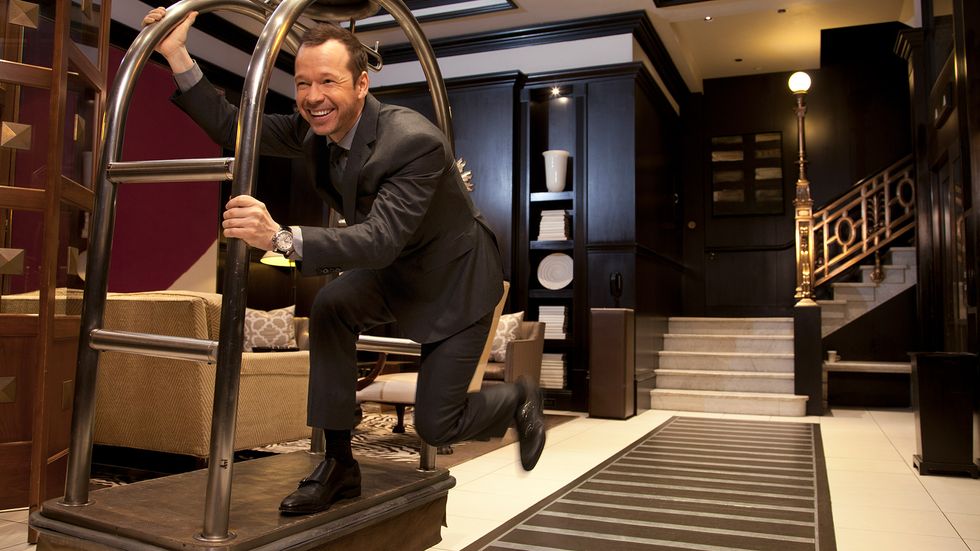 Donnie Wahlberg of Blue Bloods riding a hotel luggage cart
