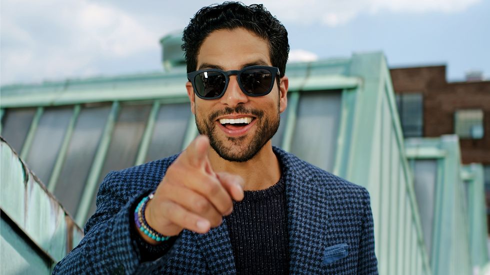 Adam Rodriguez of Criminal Minds in sunglasses pointing at camera