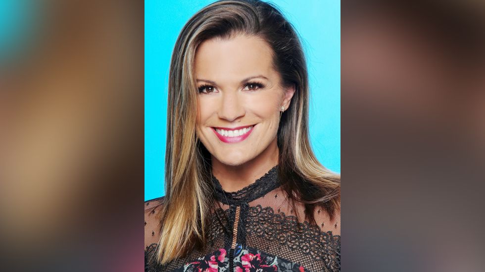 Melissa Claire Egan wears a lace and flowered top.