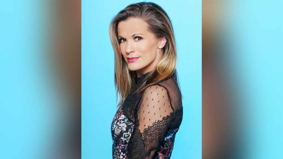 Melissa Claire Egan wears a lacey top and looks squarely at the camera.