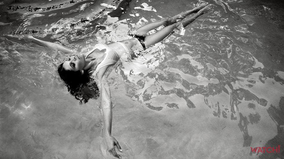 Daniela Ruah of NCIS Los Angeles floating on her back in water