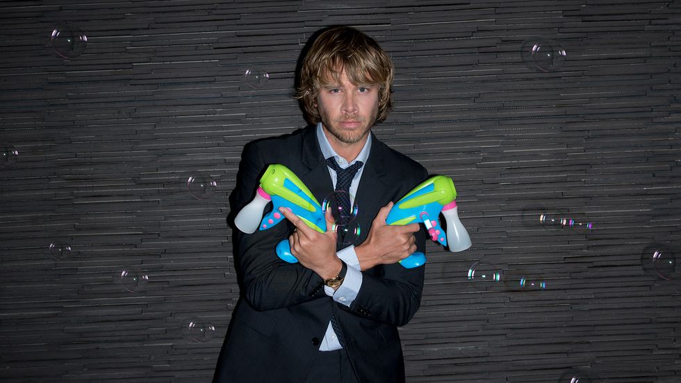 Eric Christian Olsen holding water guns