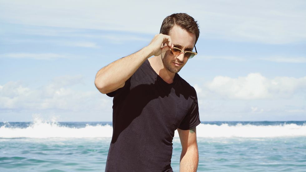Alex OLoughlin in sunglasses by the ocean