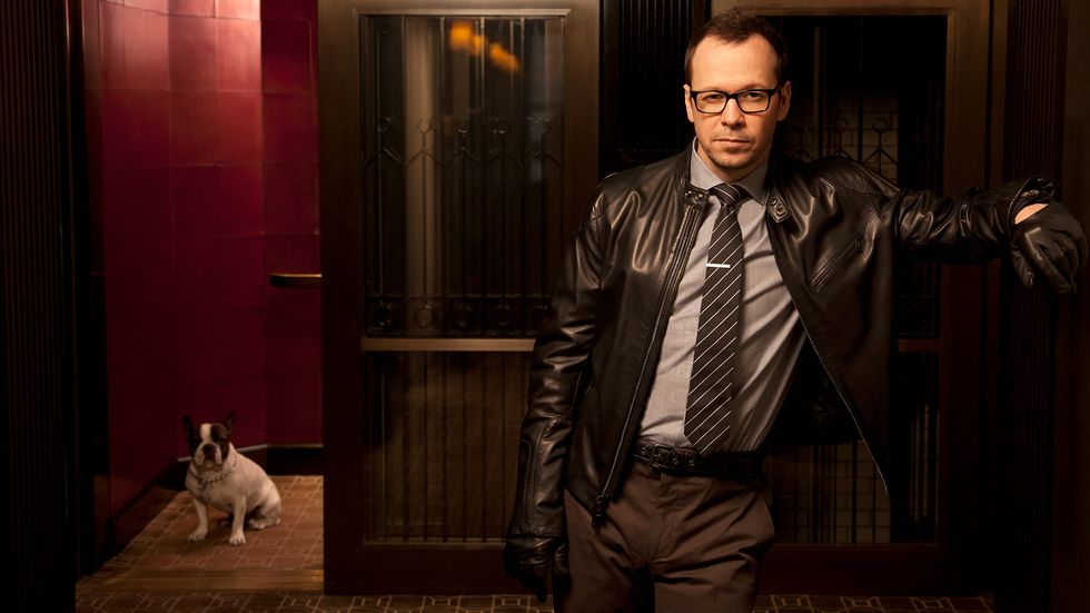 Donnie Wahlberg in black leather jacket with dog