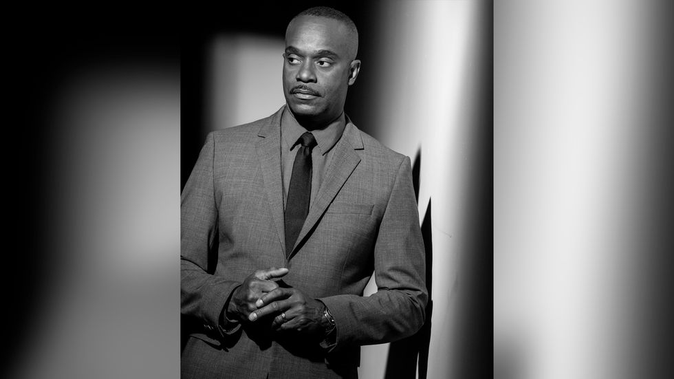 Rocky Carroll in black and grey suit