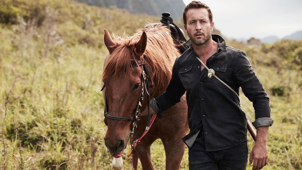 Alex O'Loughlin walking brown horse