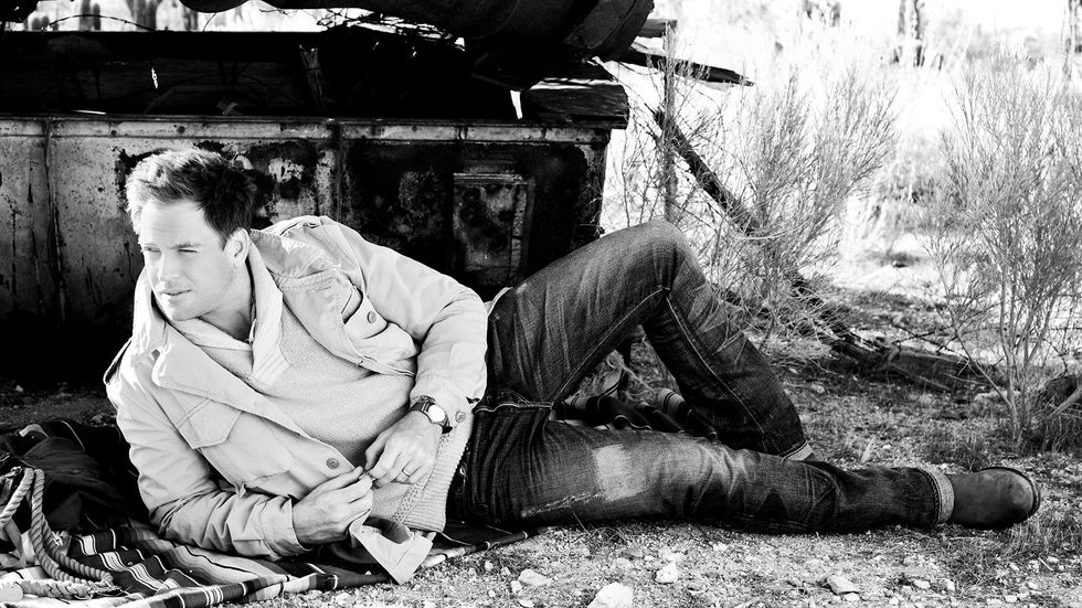 Michael Weatherly laying down in denim
