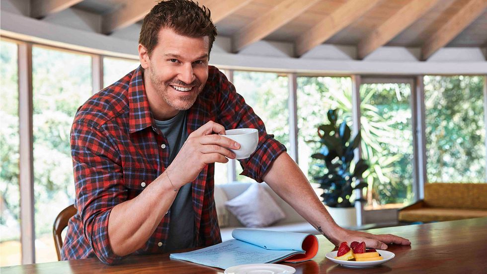 David Boreanaz drinking coffee in plaid shirt
