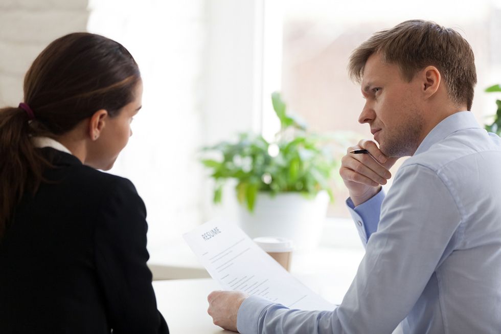 An interviewer holds a resume with an objective statement